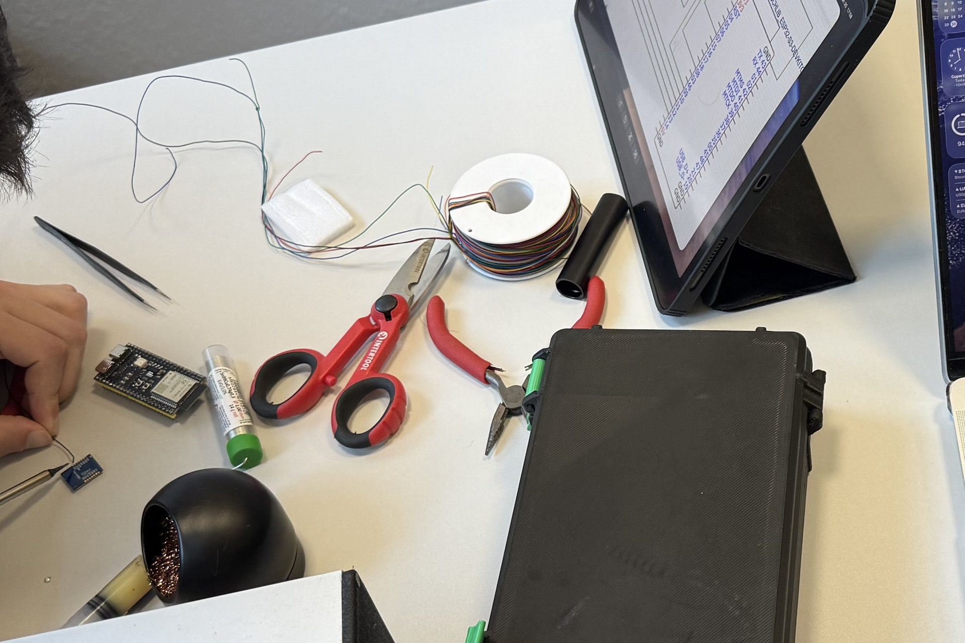 ESP32 boards, wiring tools, and a node enclosure on the Orion workbench